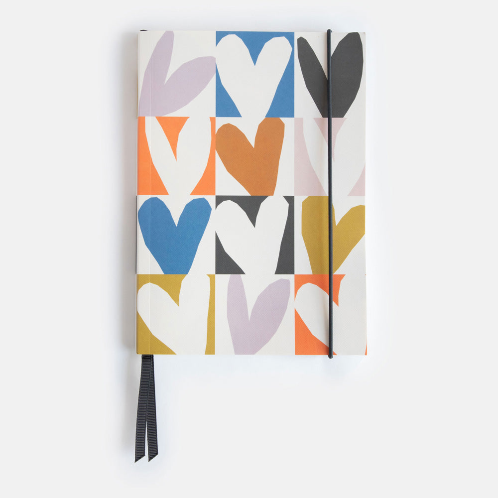 A5 softcover notebook with a multicolour hearts print, black ribbon page markers and elastic closure band