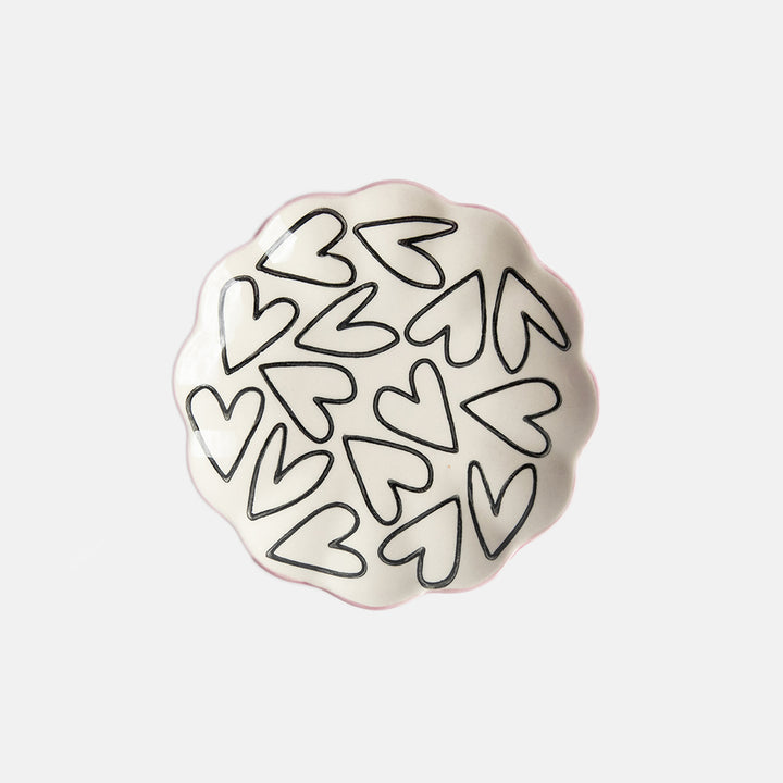 hand painted ceramic trinket dish with scalloped edges, mono heart outlines on the surface and soft pink bottom