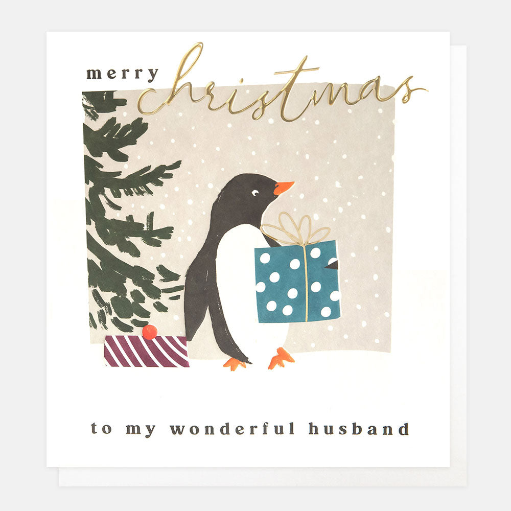 Christmas card featuring a penguin with wrapped presents and tree in the snow and the words merry Christmas to my wonderful husband