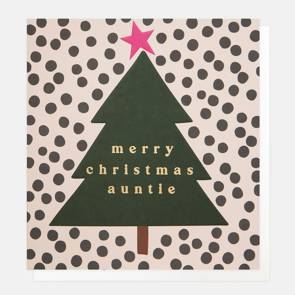 Christmas card featuring a green Christmas tree with pink star on a black spotty background and the words merry Christmas auntie