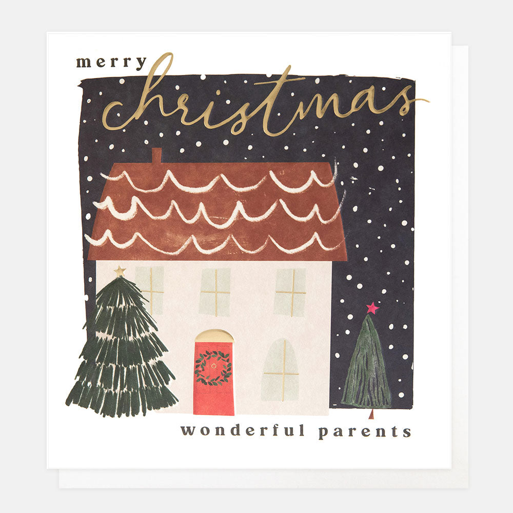 Christmas card featuring a scene of a snow covered house and Christmas trees and the wording merry Christmas wonderful parents