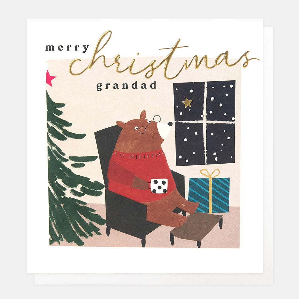 Christmas card featuring a bear sitting in a chair with a mug, presents and tree and the words merry Christmas grandad