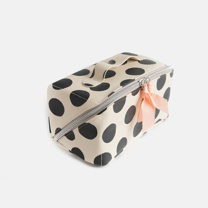 diagonal zip flat lay vegan leather wash bag in monochrome spots with top handle, silver zip and soft pink grosgrain pull