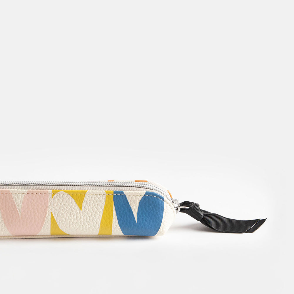 leather look PU slim pencil case in a multicolour hearts design with a black ribbon zip pull and pink striped lining