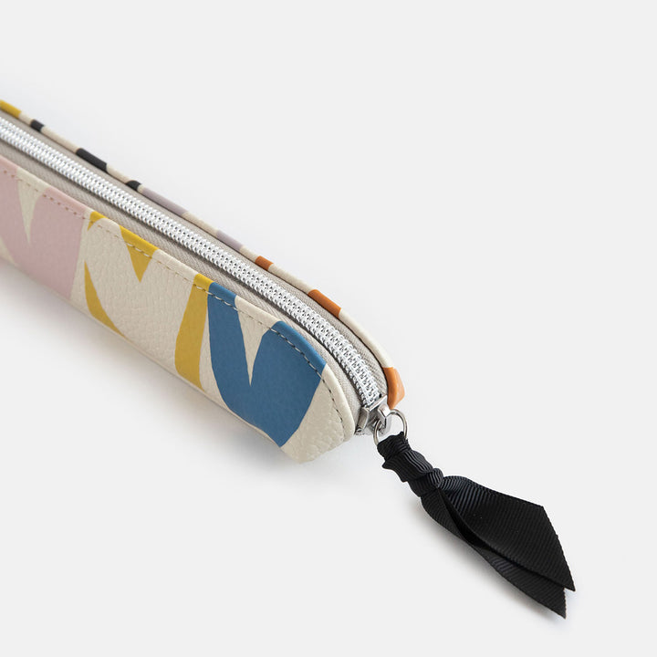 leather look PU slim pencil case in a multicolour hearts design with a black ribbon zip pull and pink striped lining