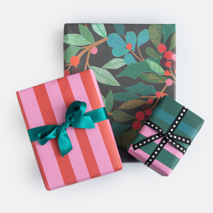 Three gift wrapped presents with decorative ribbons on a white background