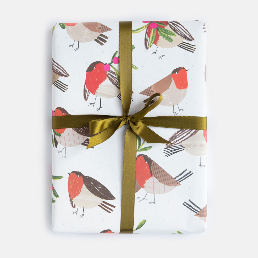 Gift wrapped in paper with robin design and gold ribbon on a white background