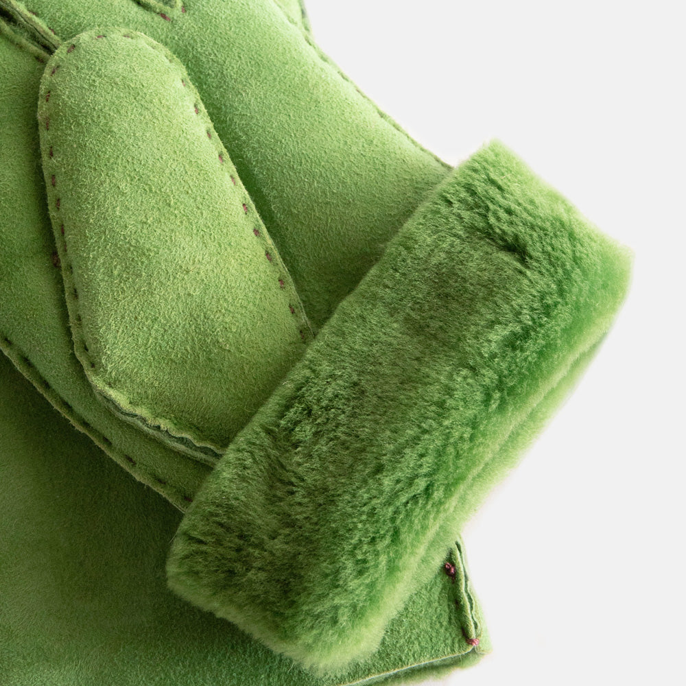 women's sheepskin shearling gloves in spring green, folding back at the wrist to show green lining