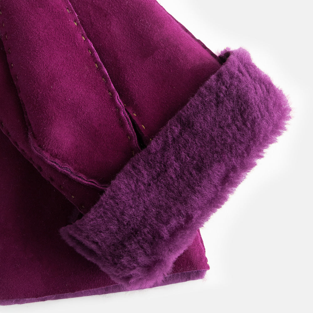 pair of gloves in purple colour folded back to show purple lining