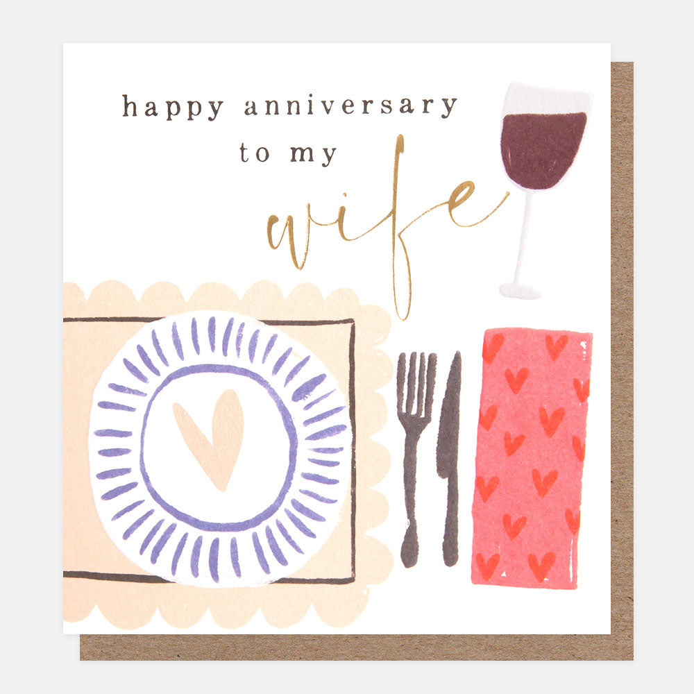 laid table with wine 'happy anniversary to my wife' card