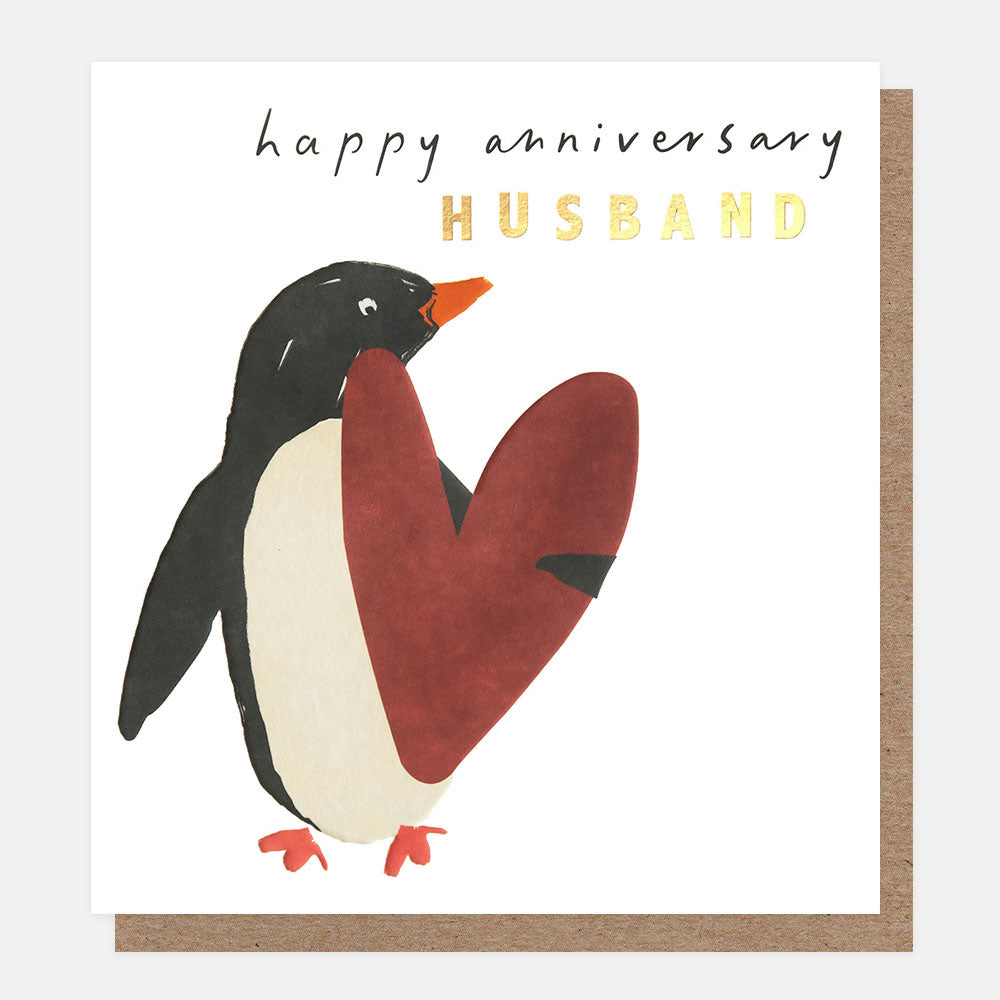 anniversary card featuring a black and white penguin holding a red love heart and wording happy anniversary husband