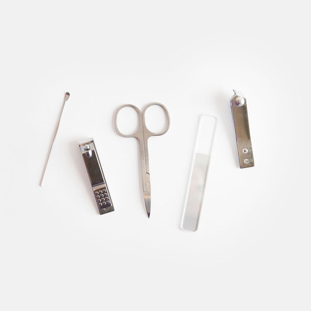 manicure set with nail file, scissors, nail clippers, cuticle clippers & cuticle tool in a spot print leather look PU holder
