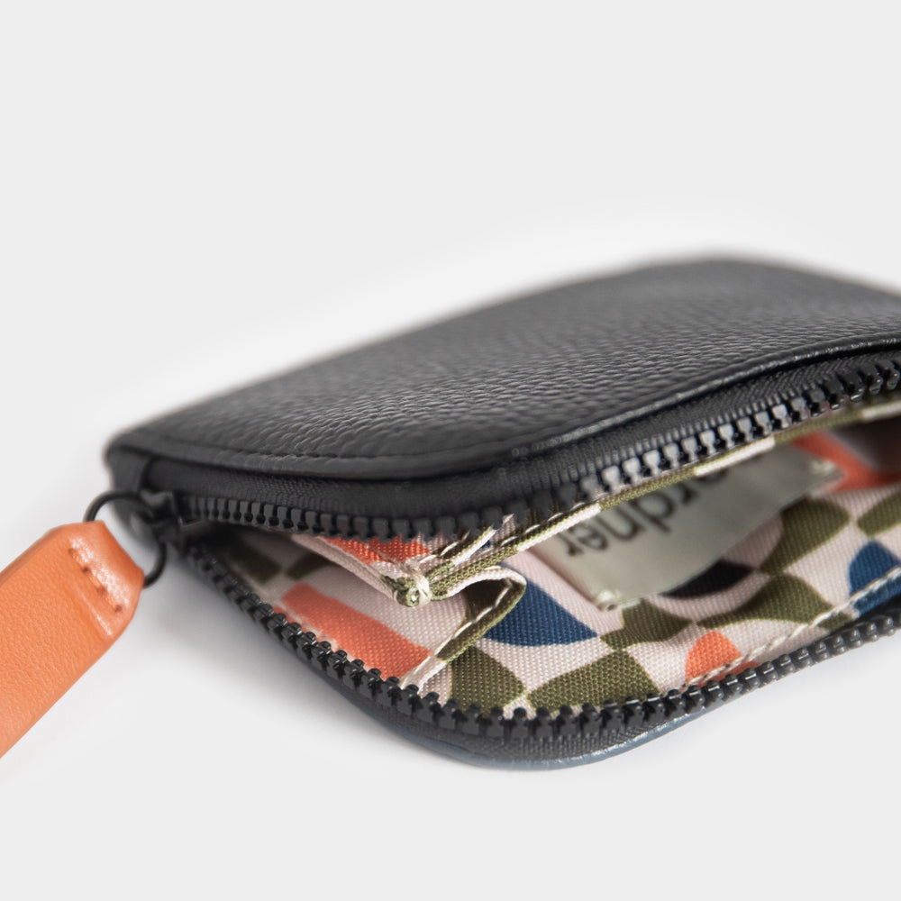 leather look corner wallet, black one side, navy blue on the other side, with retro geometric print lining