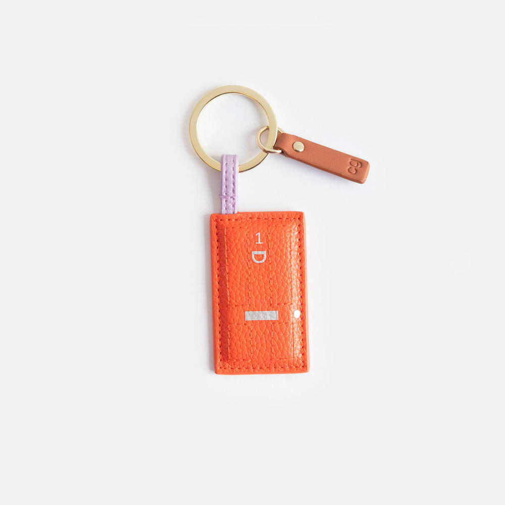 orange front door leather look PU padded keyring with a printed silver number 1 and door knocker