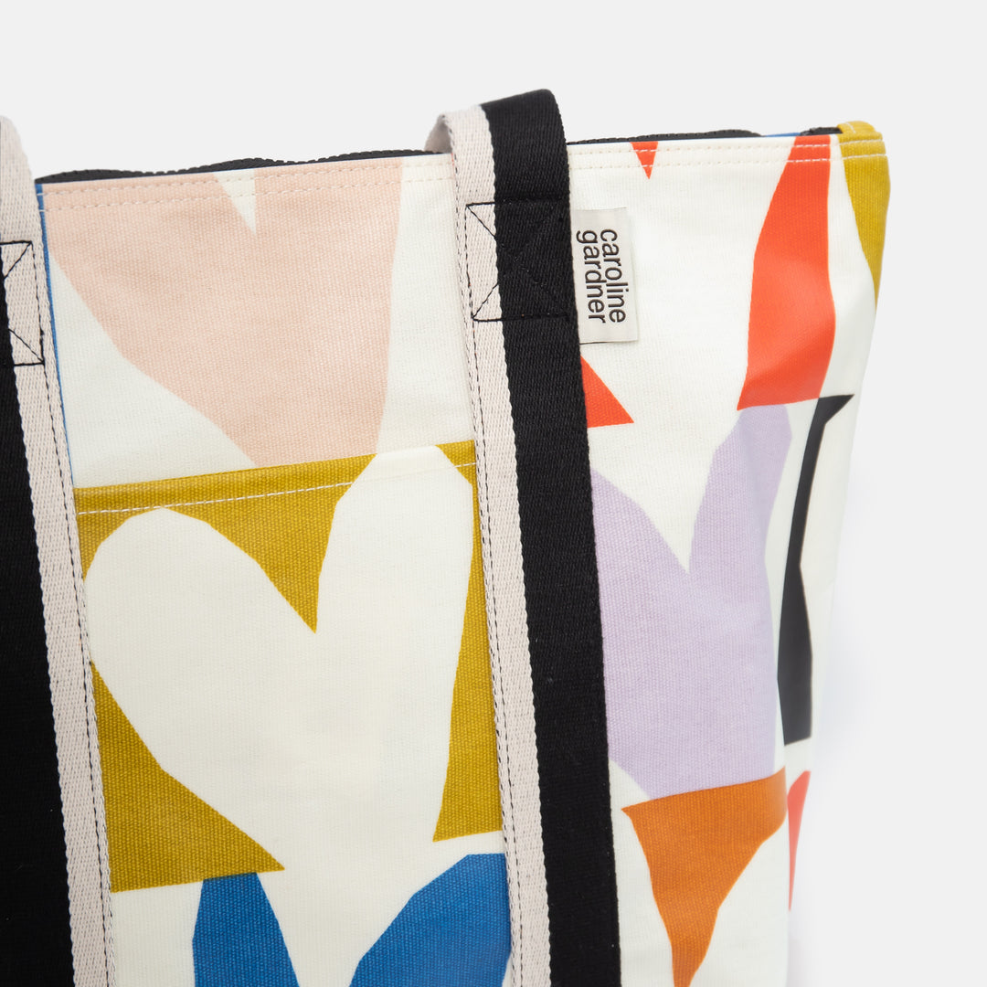 coated cotton canvas shopper style bag with bright colourful checked hearts design and black & white fabric handles