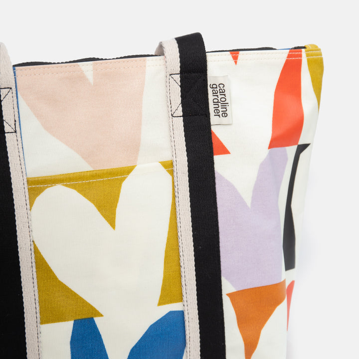 coated cotton canvas shopper style bag with bright colourful checked hearts design and black & white fabric handles