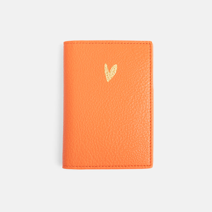 leather look passport holder in orange with gold heart on front