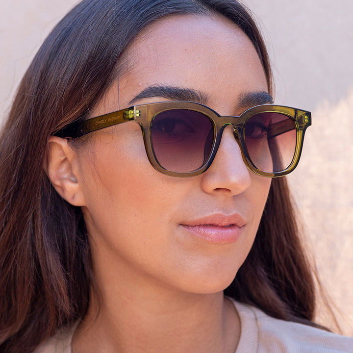 woman wearing kiwi green sunglasses with brown gradient lenses