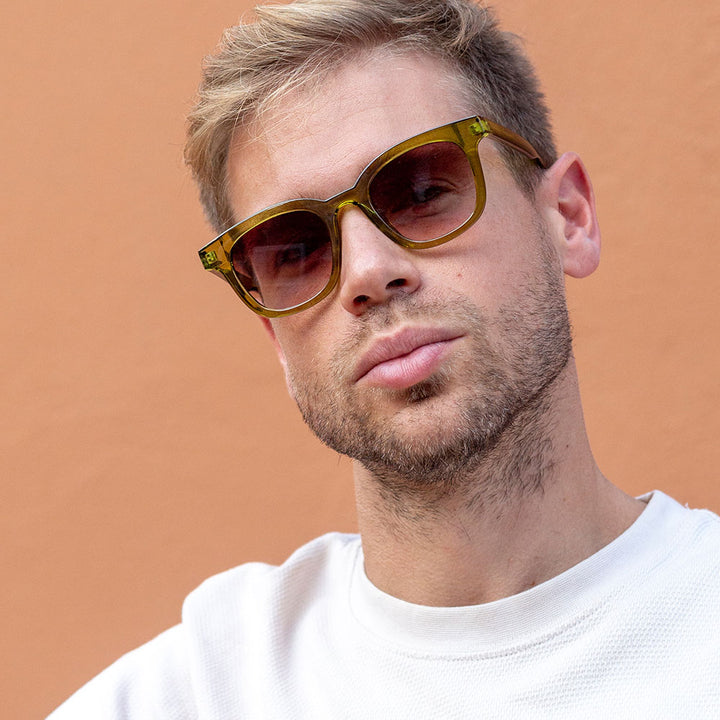 man wearing kiwi green sunglasses with brown gradient lenses
