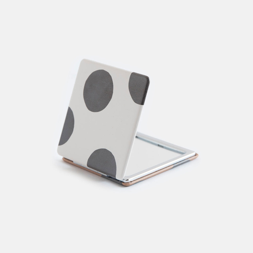 printed leather look PU square compact pocket mirror in a black and white spot print on the pront and black and brown spot on the back, with 2 mirrors and magnetic fastening