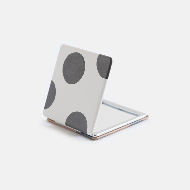 printed leather look PU square compact pocket mirror in a black and white spot print on the pront and black and brown spot on the back, with 2 mirrors and magnetic fastening