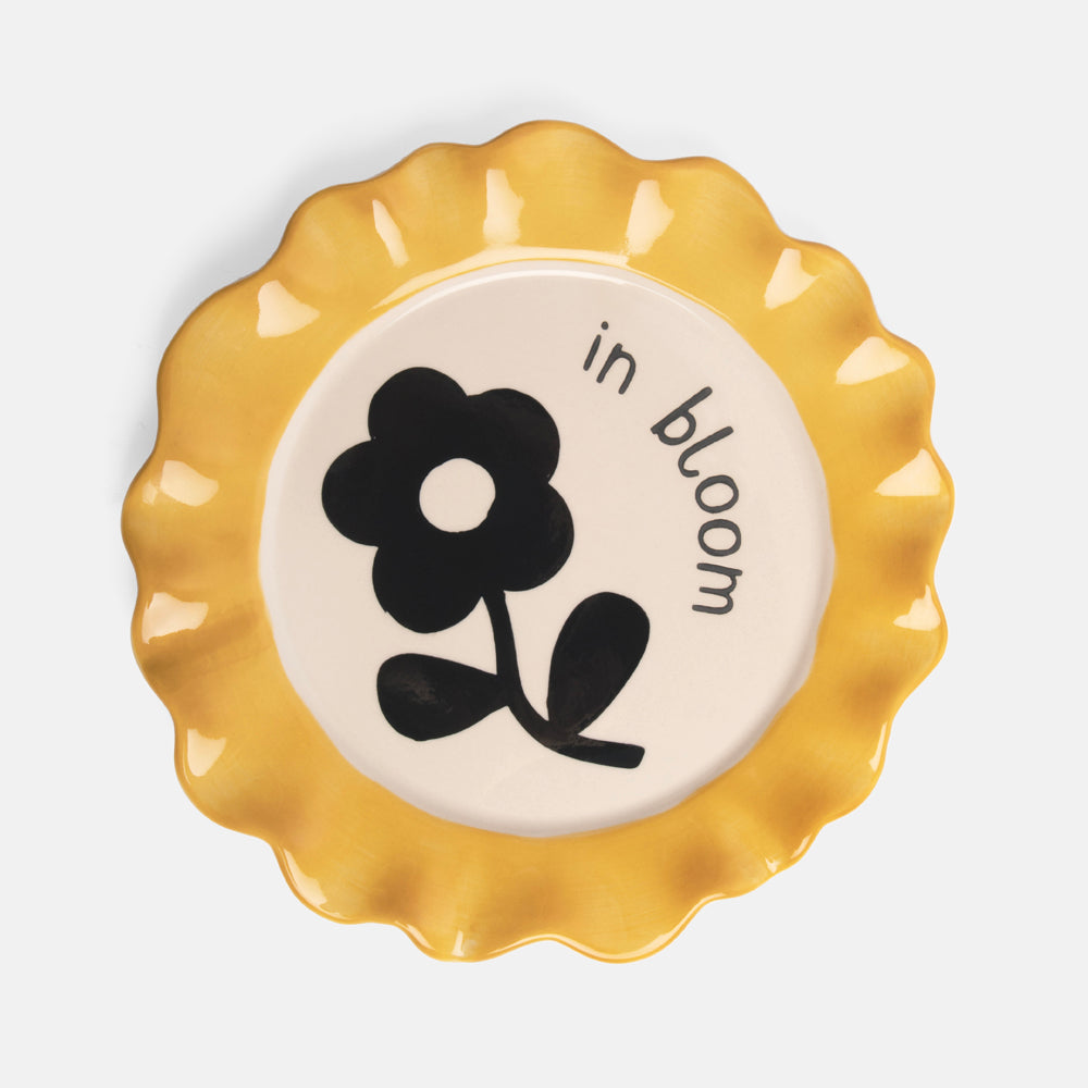 hand painted glazed stoneware plate with monochrome flower design and yellow scalloped edge