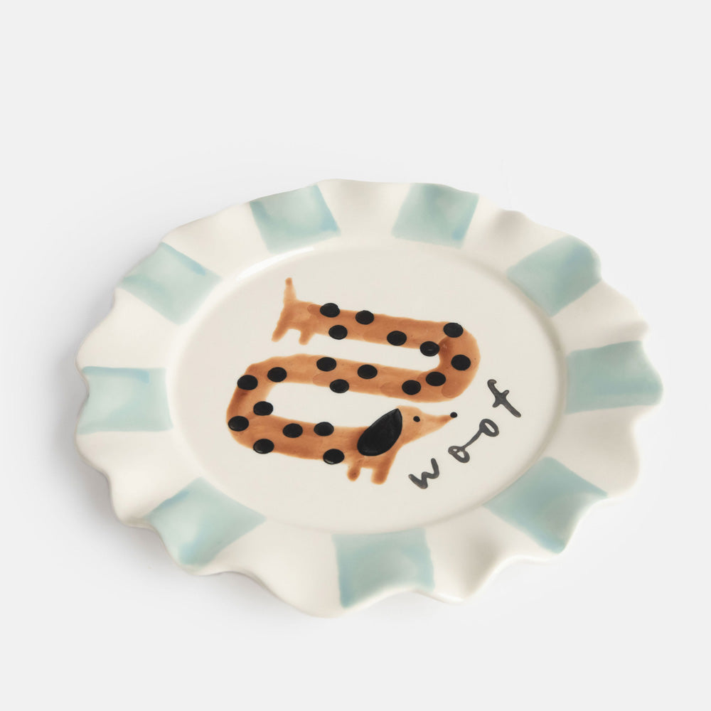 hand painted ceramic stoneware plate with light blue stripe scalloped edge, sausage dog design and 'woof' slogan