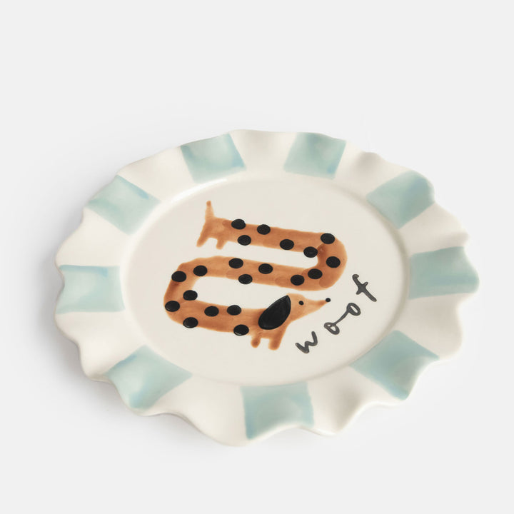 hand painted ceramic stoneware plate with light blue stripe scalloped edge, sausage dog design and 'woof' slogan