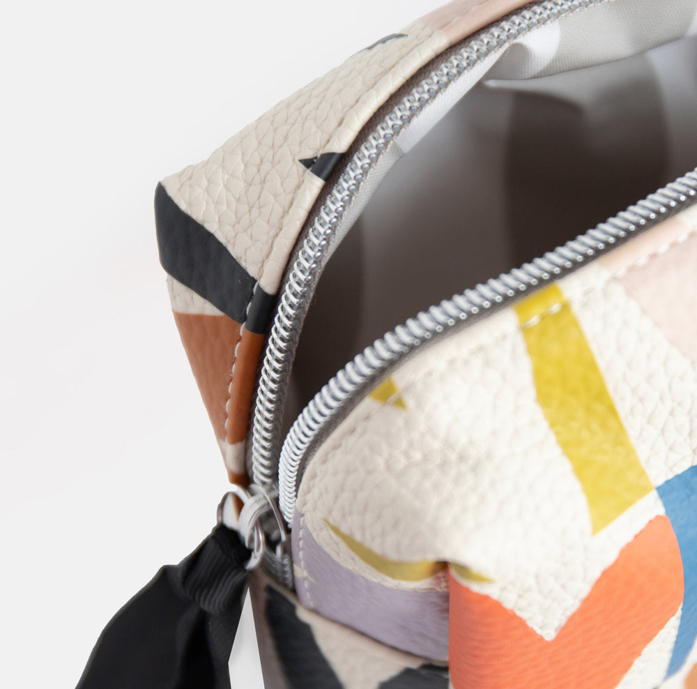 small cosmetics or wash bag with a colourful heart grid print