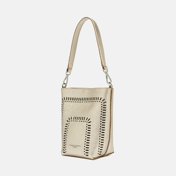 gold leather bucket tote bag with cut out design and separate crossbody and shoulder straps