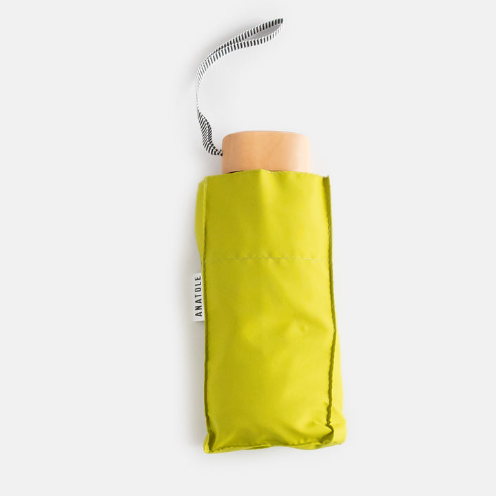 citrus yellow folding compact umbrella with wooden handle and a monochrome strap