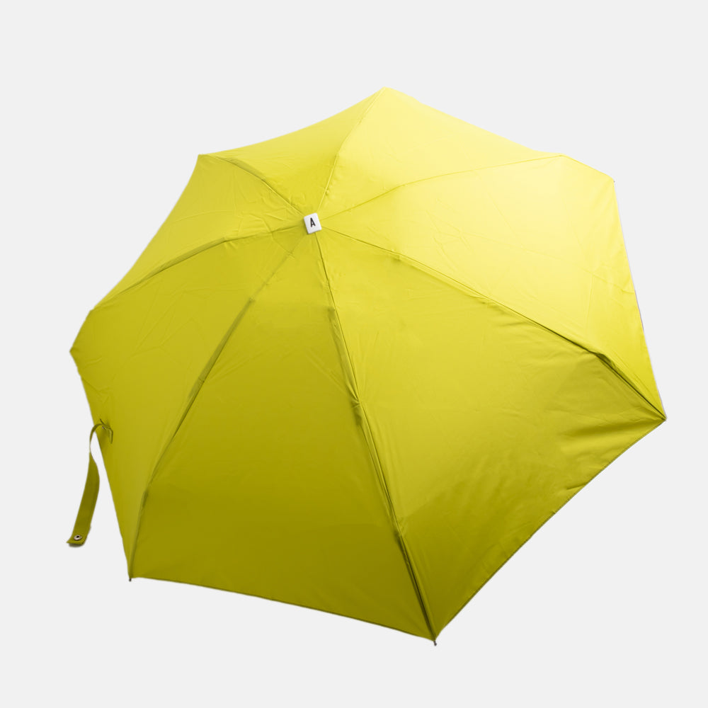 citrus yellow folding compact umbrella with wooden handle and a monochrome strap