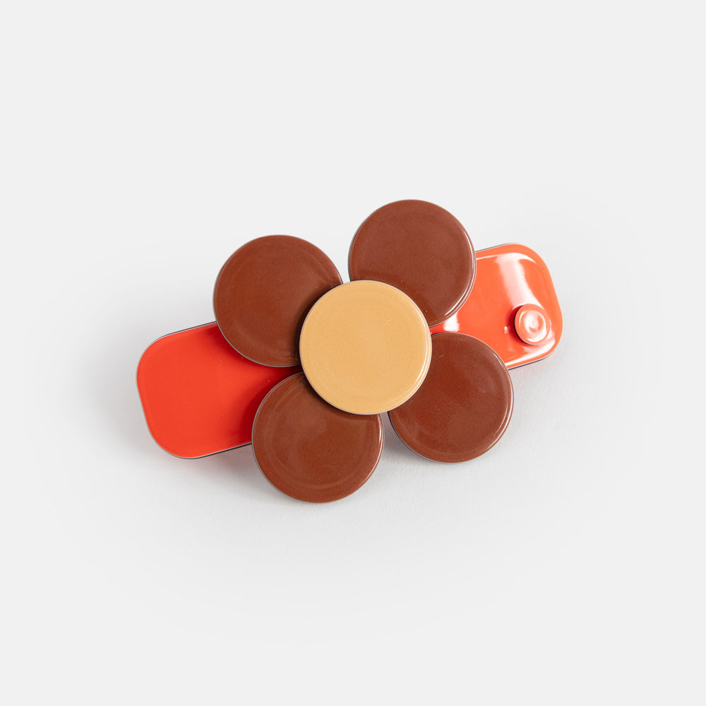 flower hair clip with orange base and brown flower