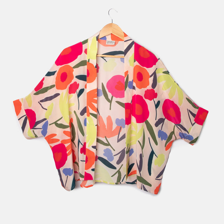 colourful abstract floral print silk short kimono top on a pale pink base