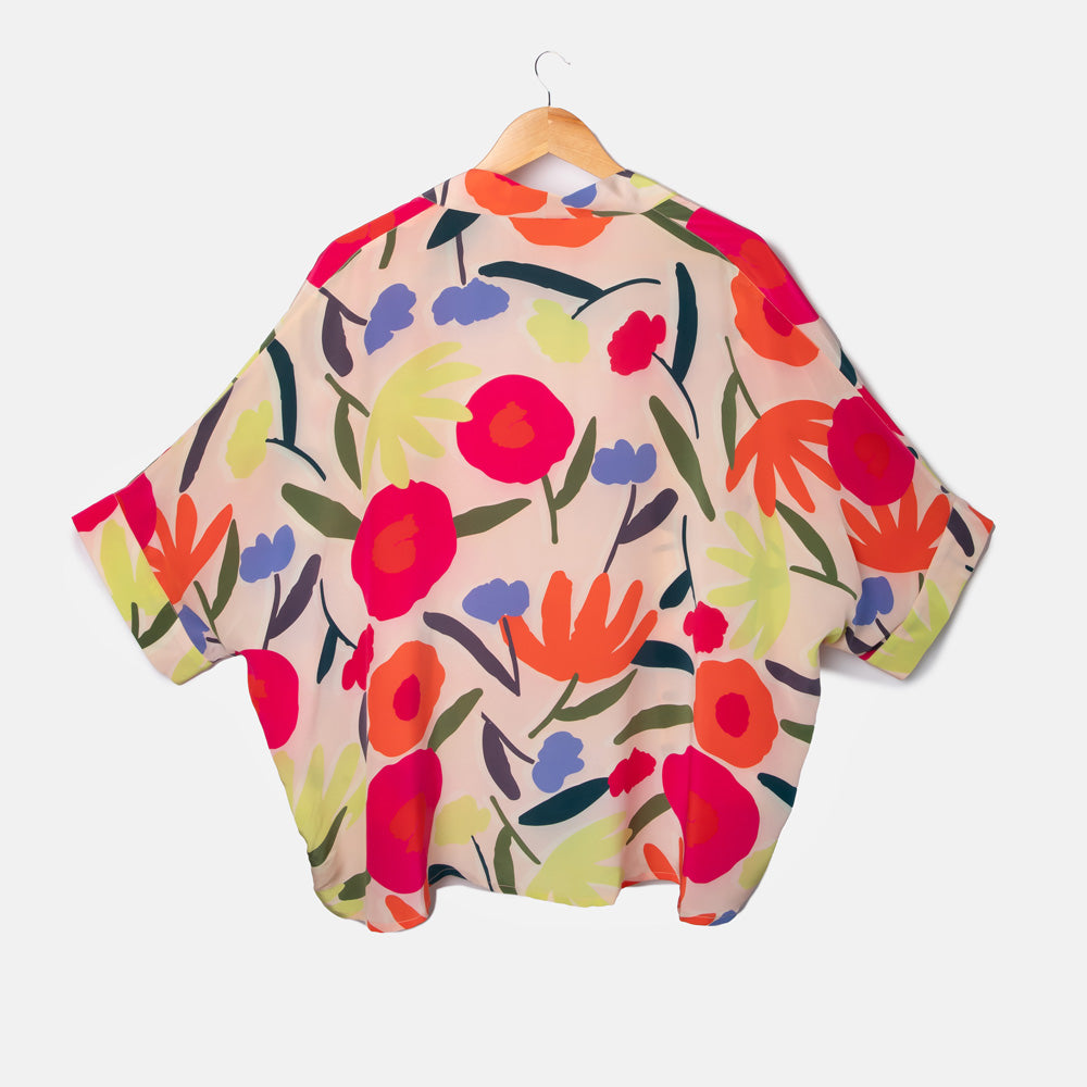colourful abstract floral print silk short kimono top on a pale pink base