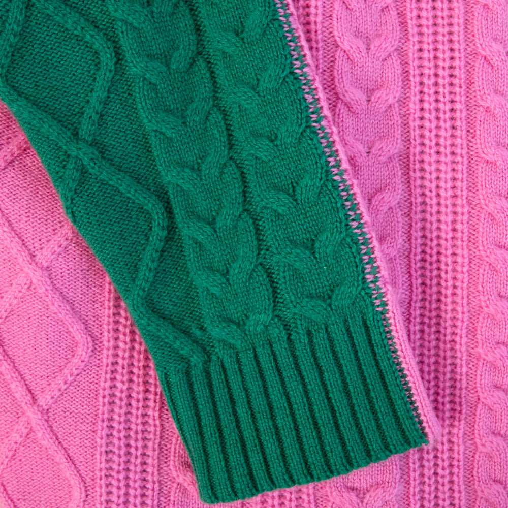 Close-up of a pink and green knitted fabric with cable pattern
