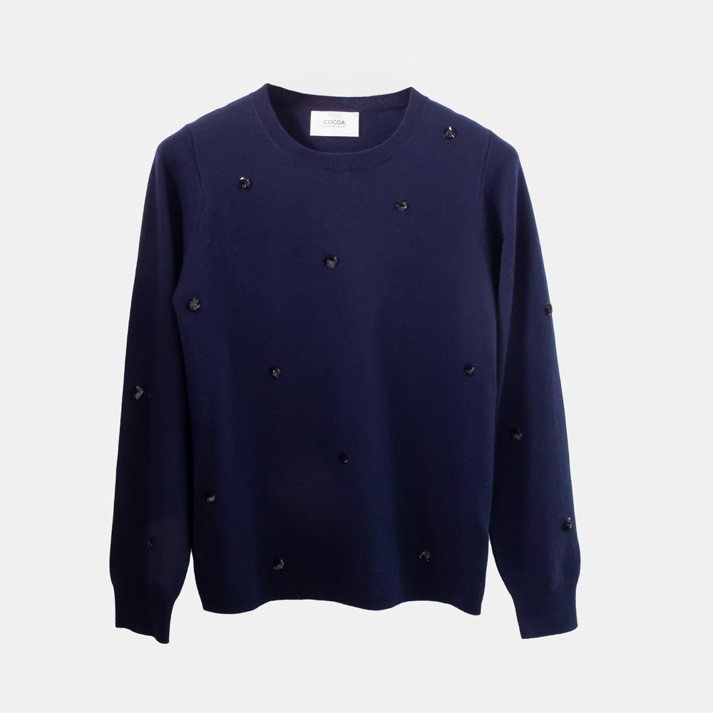 Navy blue sweater with sequin details on a light grey background