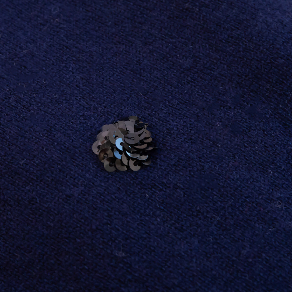 sequin cluster on a dark blue fabric background