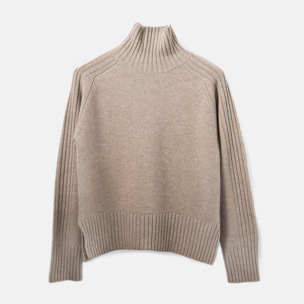 Beige turtleneck sweater on a light gray background