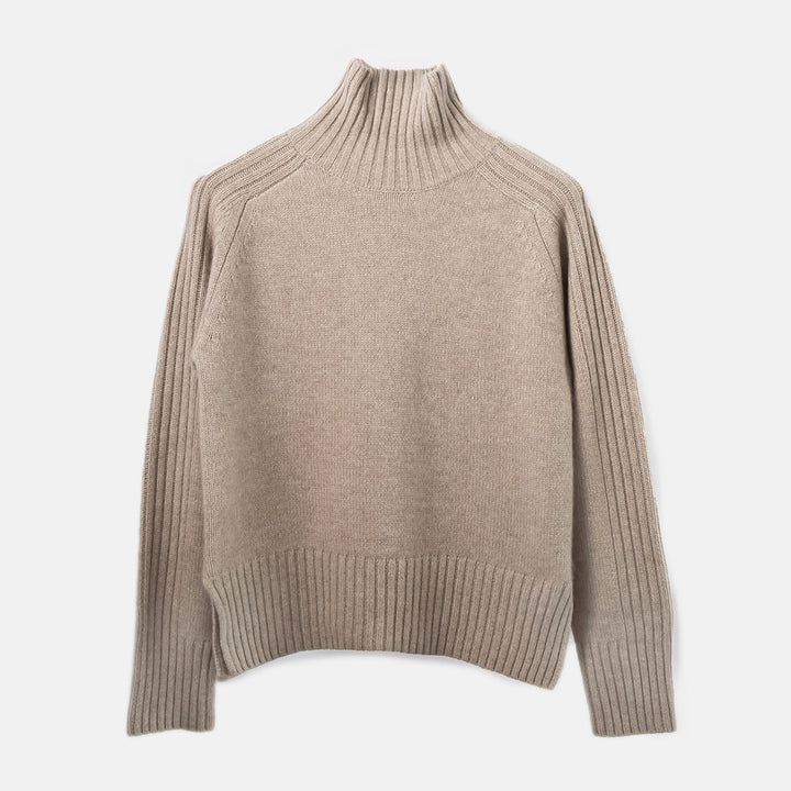 Beige turtleneck sweater on a light gray background