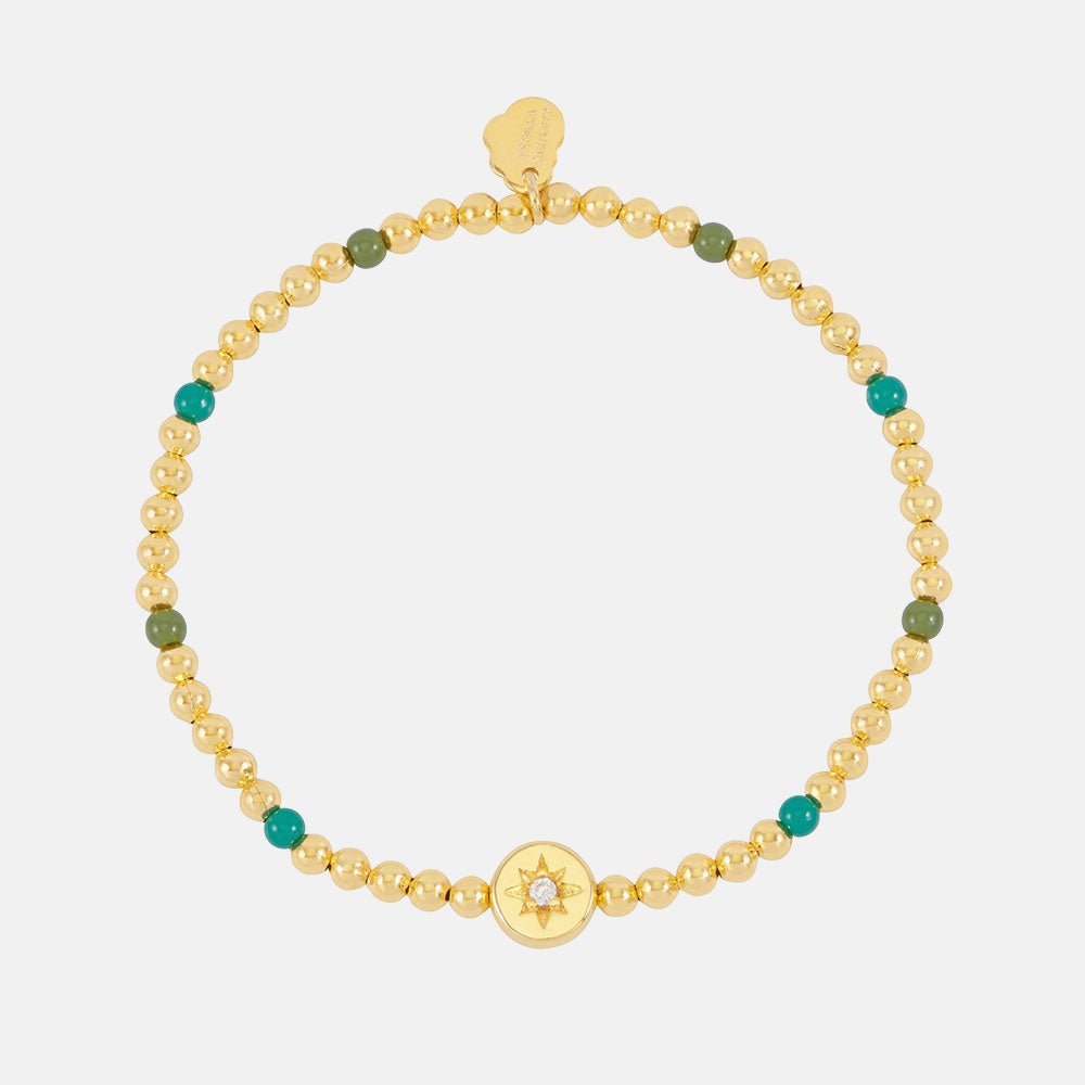 gold plated and green enamel bead bracelet with gold coin charm featuring a cubic zirconia star