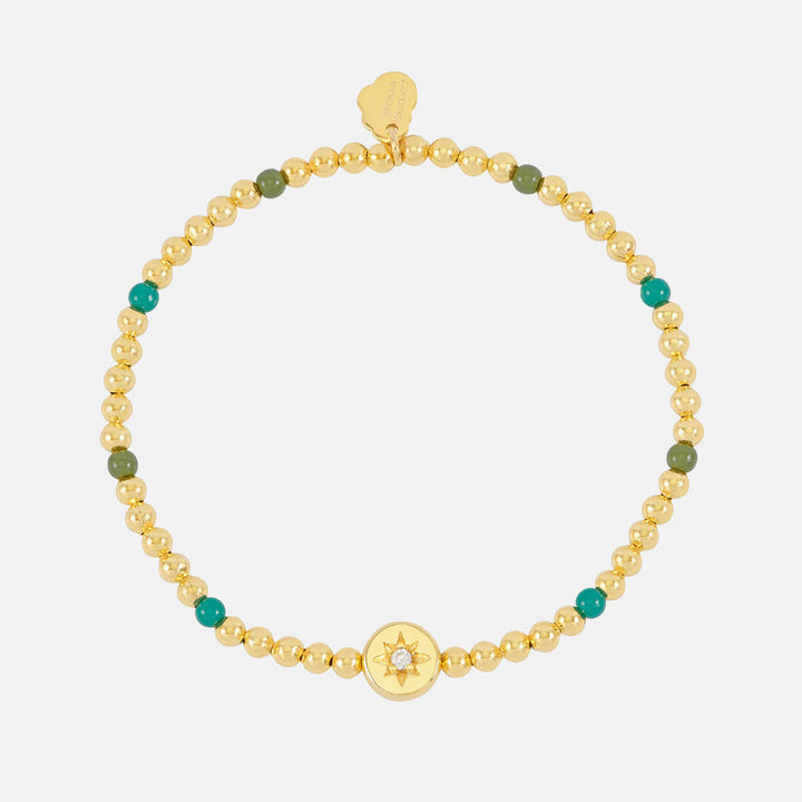 gold plated and green enamel bead bracelet with gold coin charm featuring a cubic zirconia star