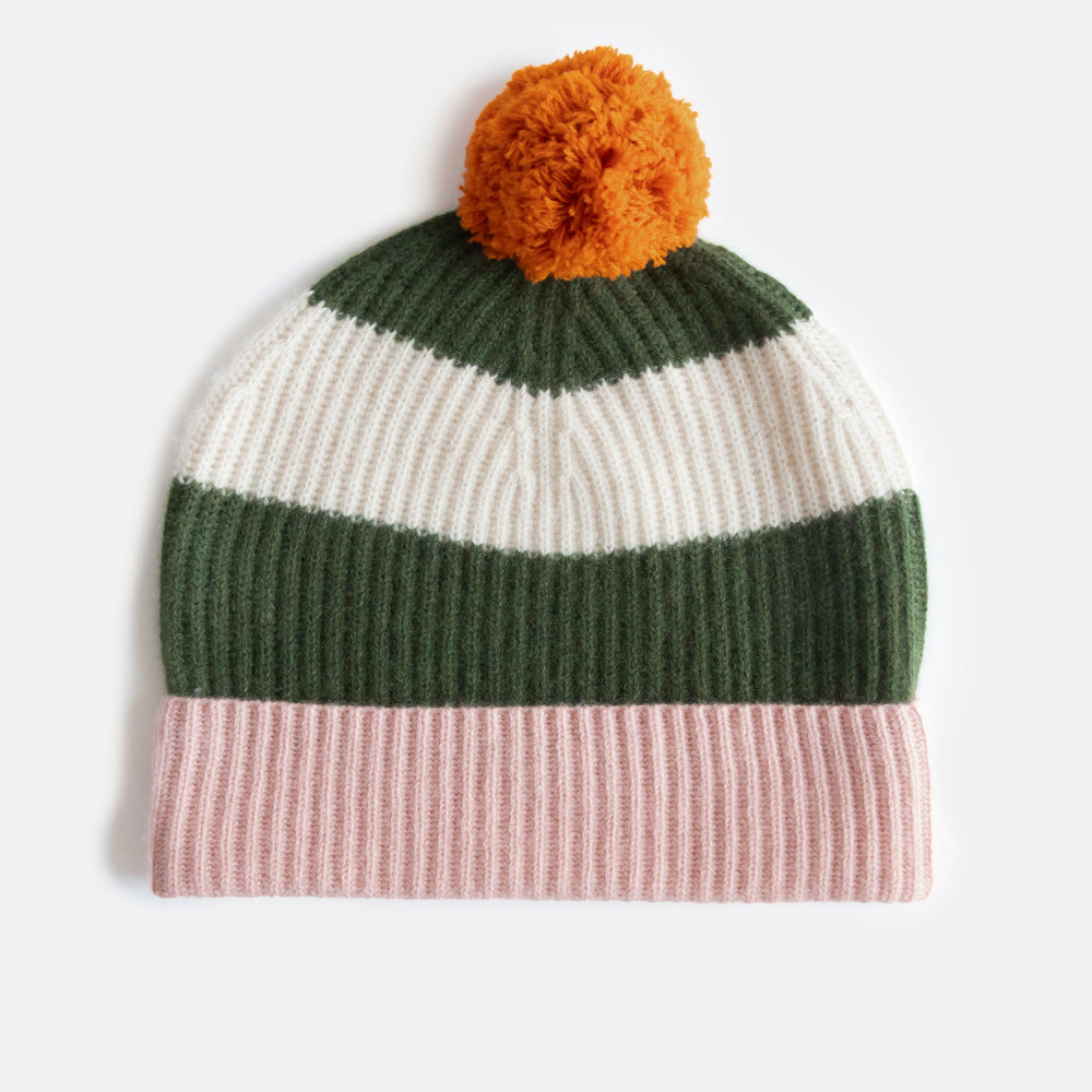 Knitted cashmere beanie in green & cream stripe, pink cuff and orange pom-pom on a white background
