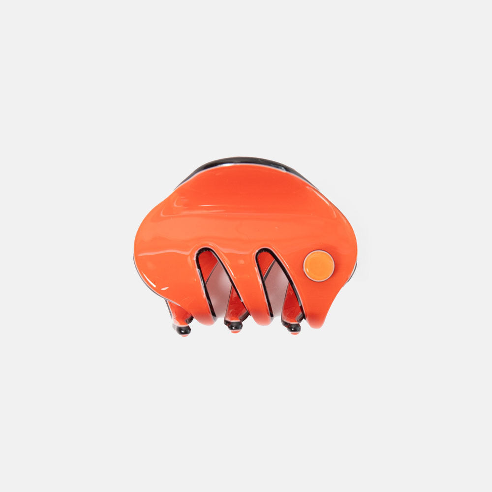 Orange hair claw on a light grey background