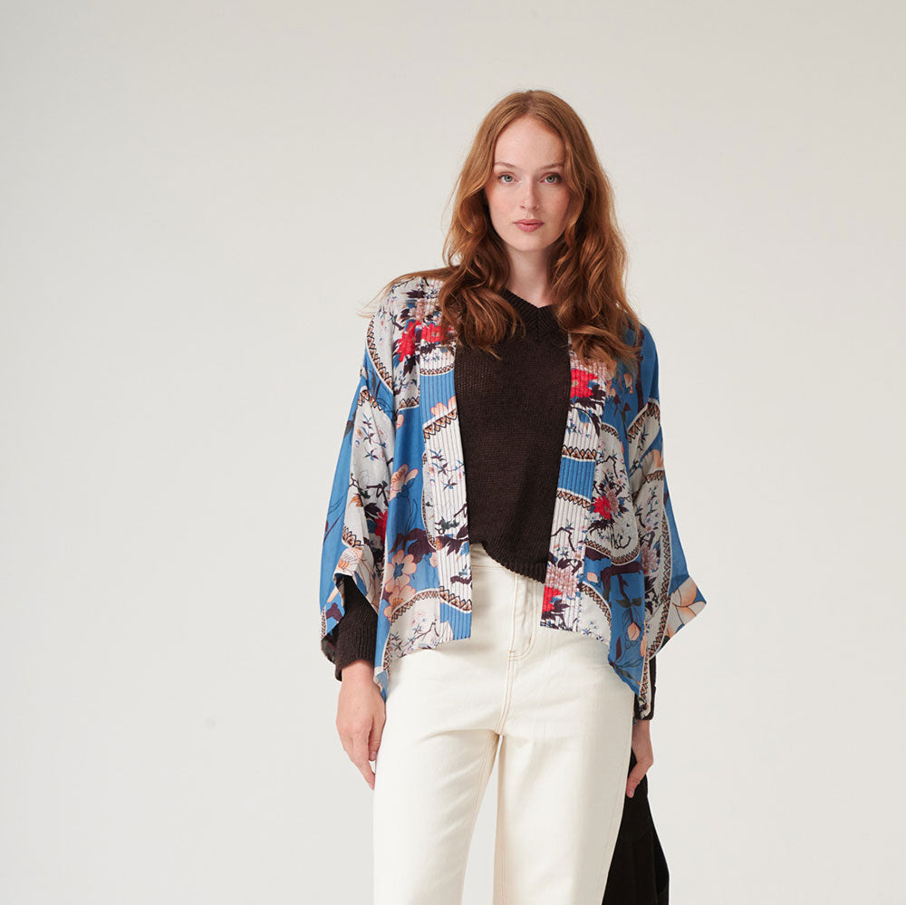 women's short kimono with print of decorative floral plates and white magnolia on a bright blue base