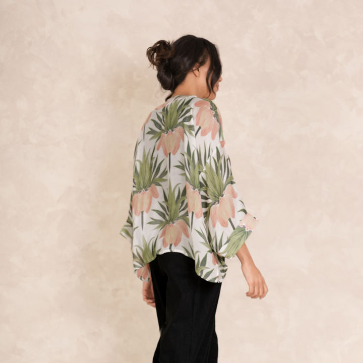 women's short kimono featuring a print of orange crown imperial flowers and green leaves on an ivory base