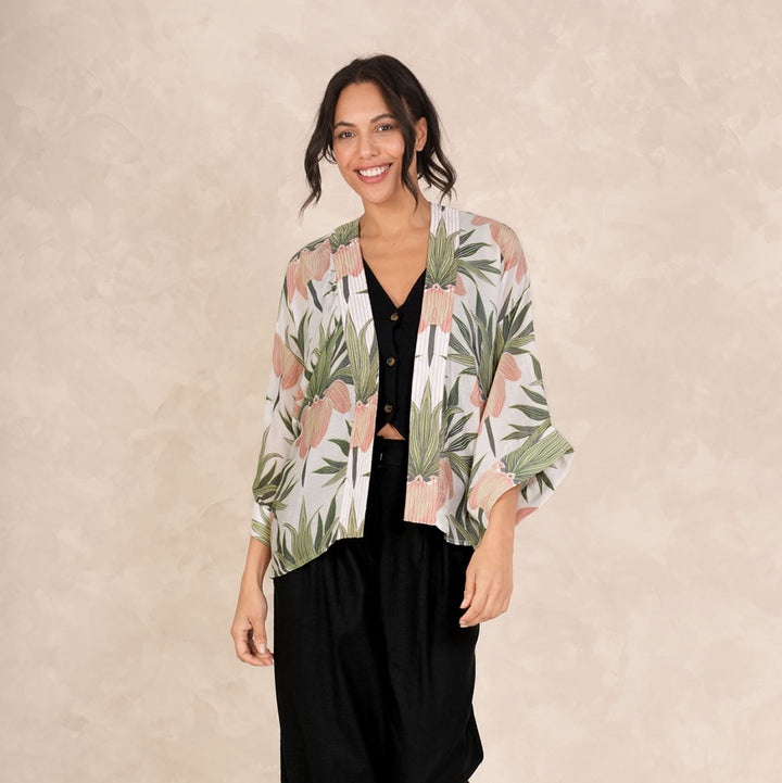 women's short kimono featuring a print of orange crown imperial flowers and green leaves on an ivory base