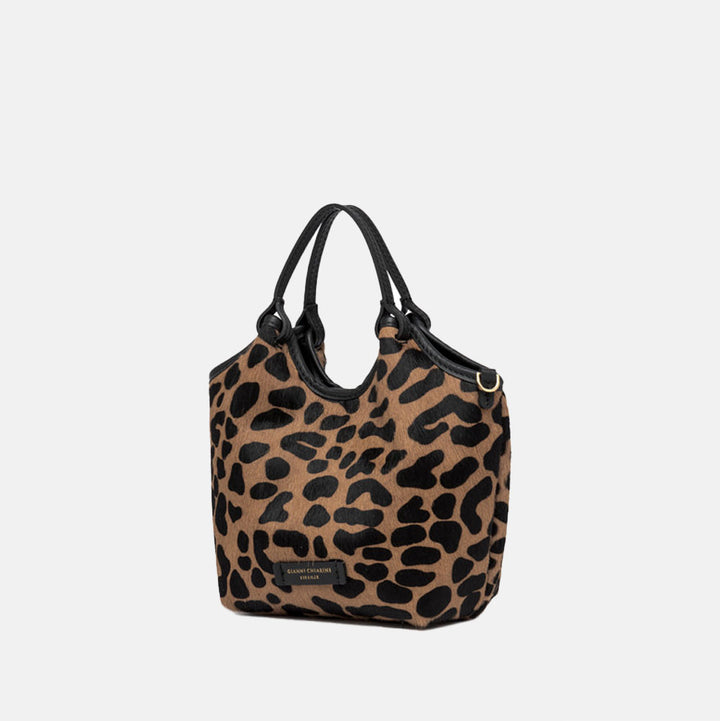 Leopard print handbag with black handles on a light gray background