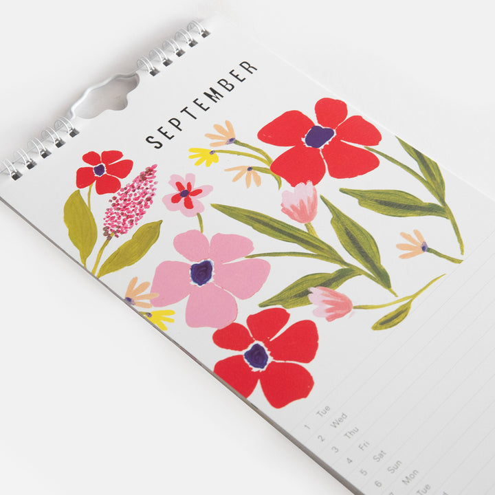 2026 slim wall calendar September month view page featuring a pink & red floral design at the top