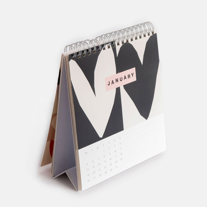 2026 desk calendar showing January's month view page with a block print monochrome heart design